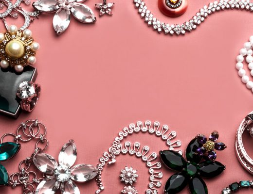 Beautiful jewelry with precious stones for women on a pink background